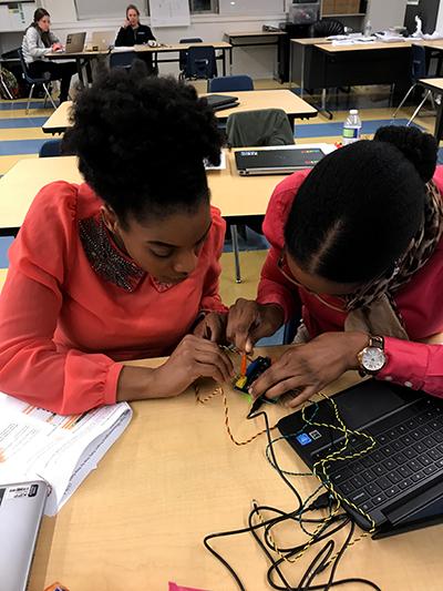 Students work on their coding projects on laptops